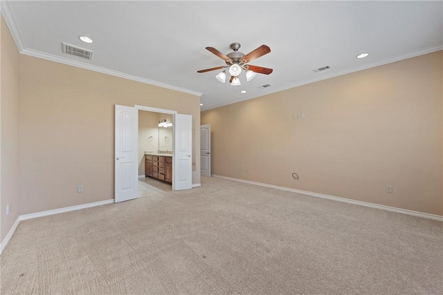 empty room featuring ceiling fan, ornamental molding, and light carpet