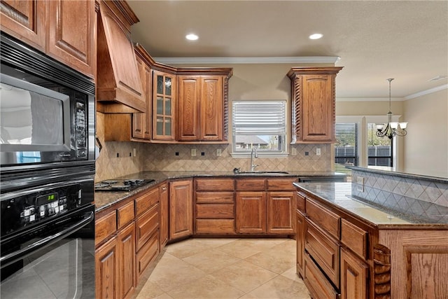 kitchen featuring decorative backsplash, premium range hood, sink, black appliances, and a notable chandelier