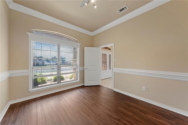 unfurnished room with ornamental molding and dark wood-type flooring