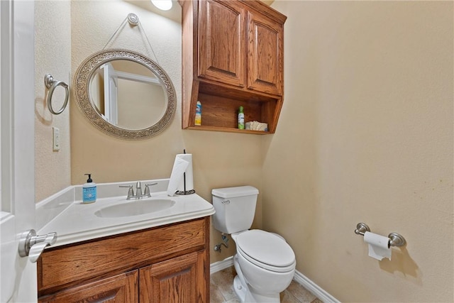 bathroom featuring tile patterned flooring, vanity, and toilet