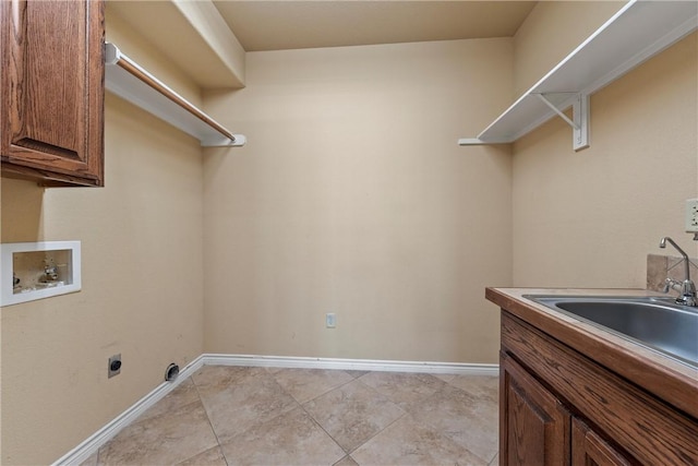 washroom featuring cabinets, sink, hookup for a washing machine, light tile patterned floors, and hookup for an electric dryer