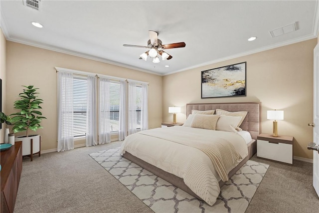 carpeted bedroom featuring ceiling fan and crown molding