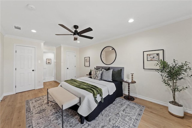 bedroom with ceiling fan, ornamental molding, and light wood-type flooring