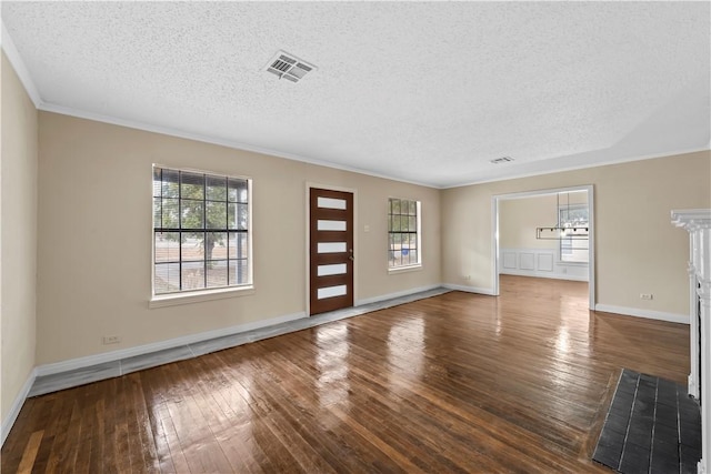 unfurnished living room with dark hardwood / wood-style floors, crown molding, a textured ceiling, and an inviting chandelier