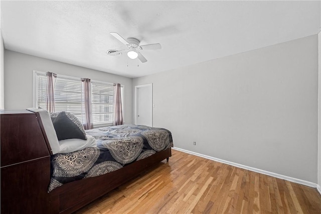 bedroom with ceiling fan and light hardwood / wood-style flooring