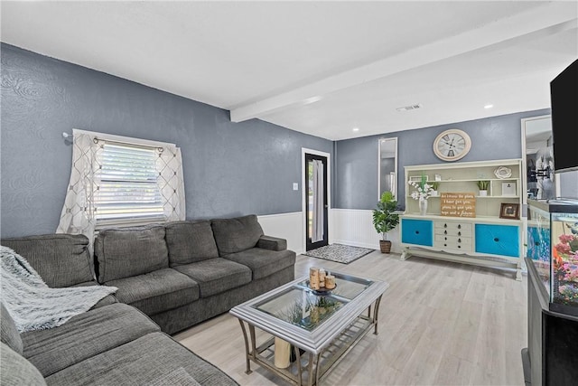 living room with beam ceiling and light wood-type flooring