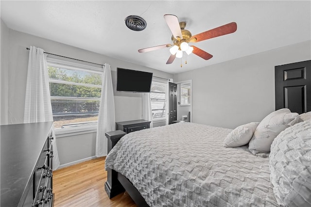 bedroom with light hardwood / wood-style floors and ceiling fan