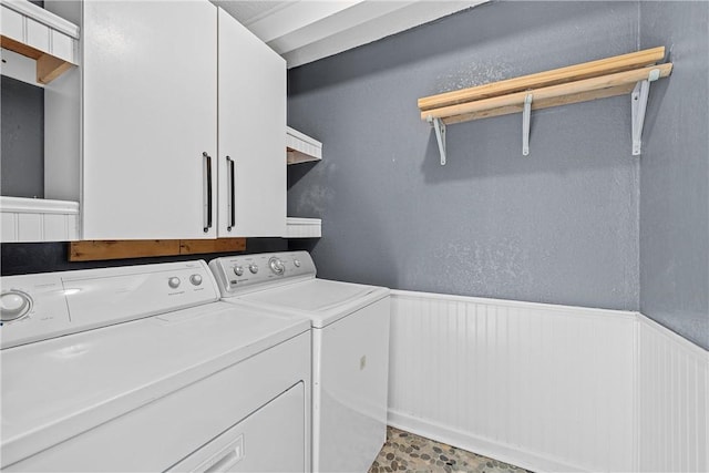 laundry area featuring cabinets and independent washer and dryer