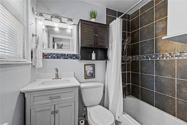 full bathroom featuring vanity, shower / bath combination with curtain, and toilet