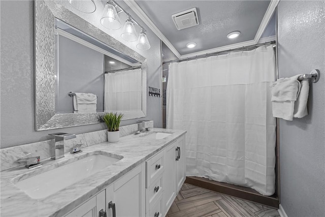 bathroom featuring parquet floors, ornamental molding, a textured ceiling, vanity, and a shower with shower curtain