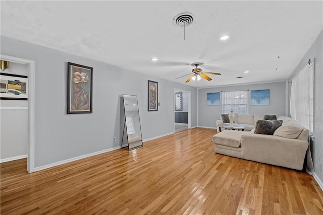 living room with ceiling fan and light hardwood / wood-style floors