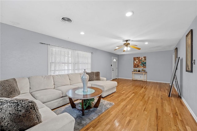 living room with ceiling fan and hardwood / wood-style floors