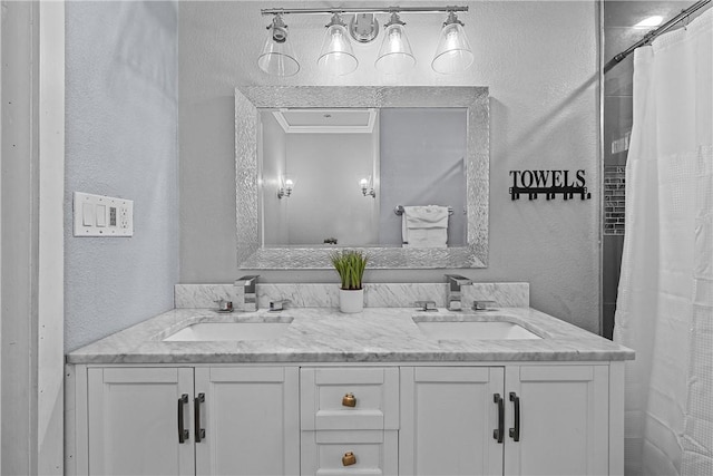 bathroom featuring curtained shower and vanity