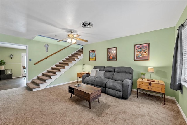 living room featuring carpet and ceiling fan