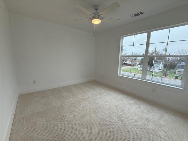 unfurnished room with ceiling fan and light carpet