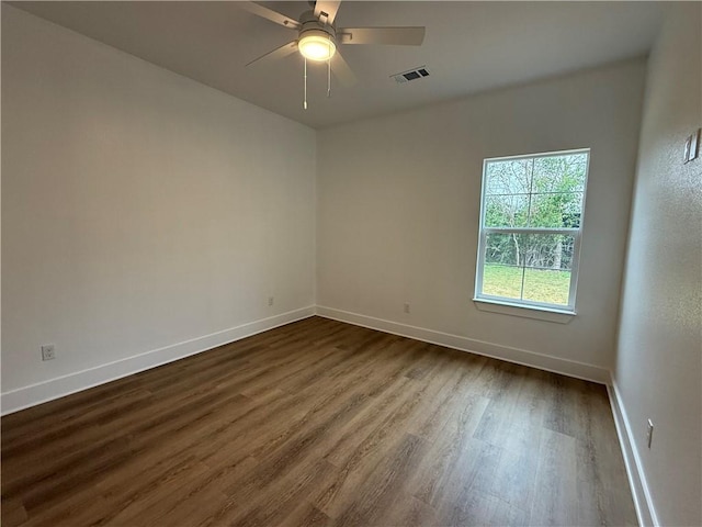 spare room featuring dark hardwood / wood-style flooring and ceiling fan