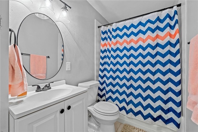 full bathroom featuring tile patterned flooring, vanity, toilet, and shower / tub combo with curtain