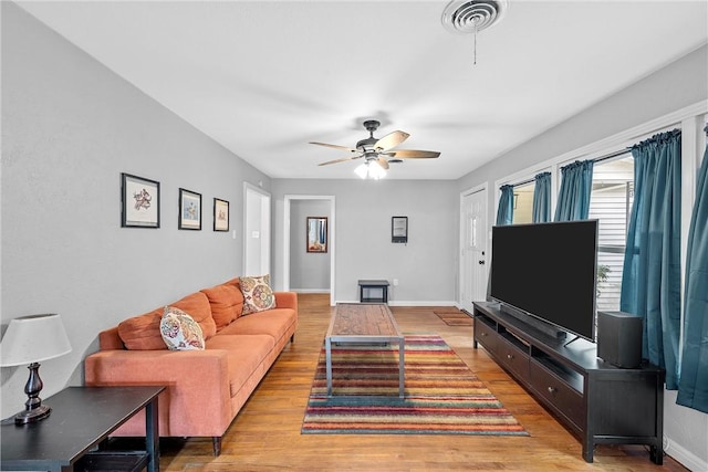 living room featuring ceiling fan and light hardwood / wood-style flooring