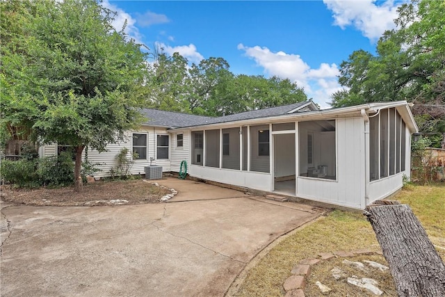 rear view of house with a sunroom and cooling unit