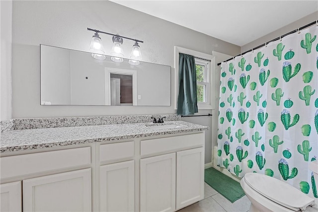 bathroom with tile patterned flooring, vanity, toilet, and curtained shower