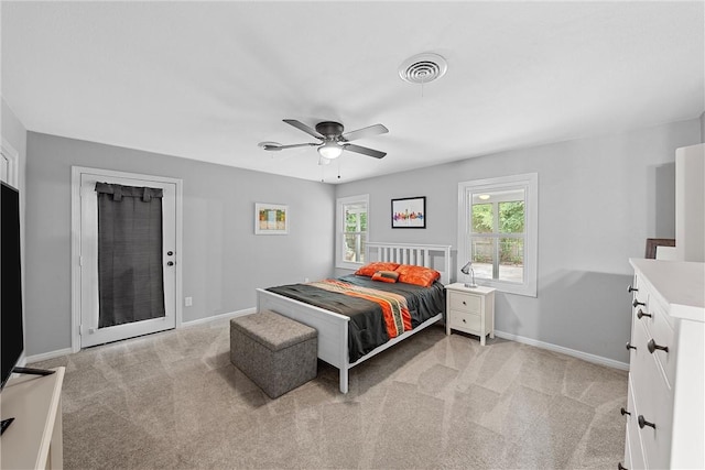 bedroom with ceiling fan and light carpet