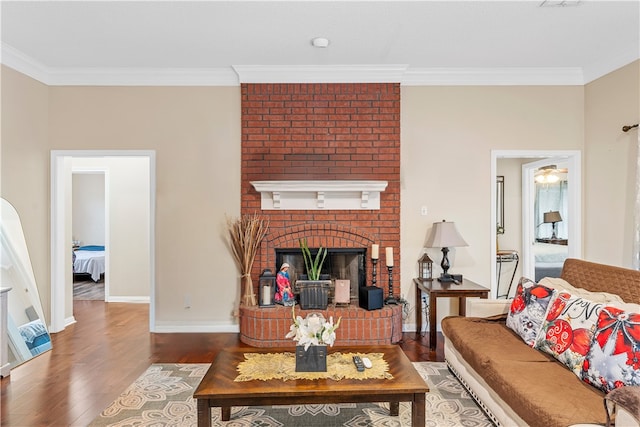 living room featuring a fireplace, hardwood / wood-style floors, and ornamental molding