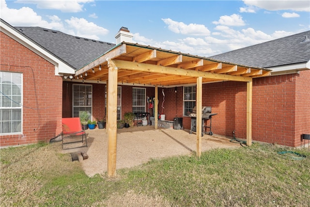 back of house with a patio and a yard