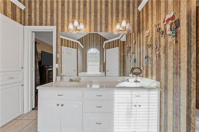 bathroom with tile patterned flooring, crown molding, and vanity