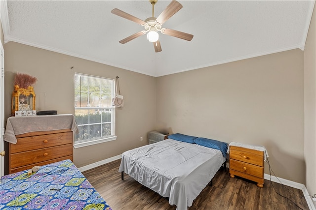 bedroom with ceiling fan, ornamental molding, and dark wood-type flooring