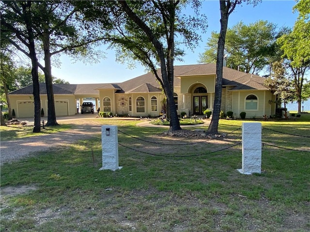 ranch-style house featuring a front yard and a garage