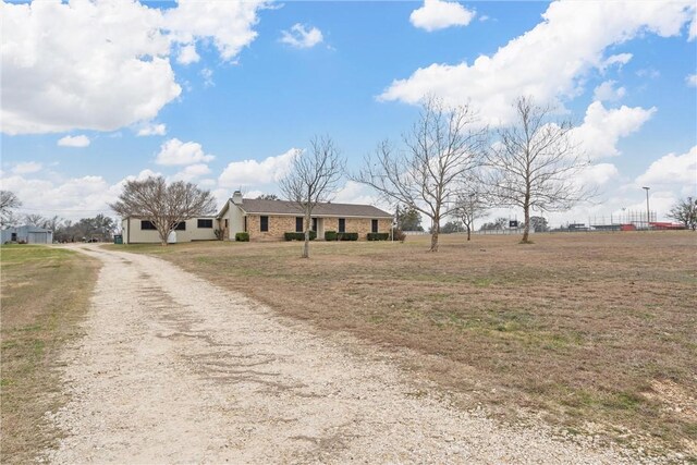 view of front of home with driveway and a chimney