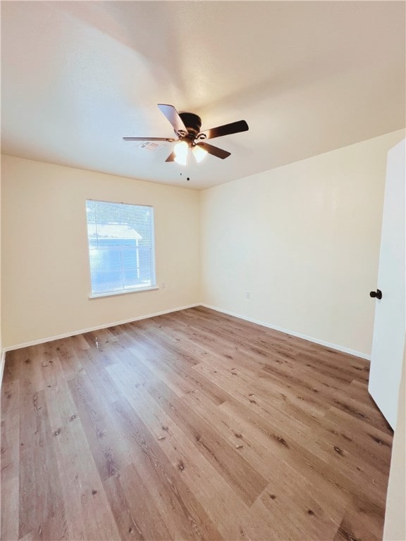 empty room with hardwood / wood-style floors and ceiling fan