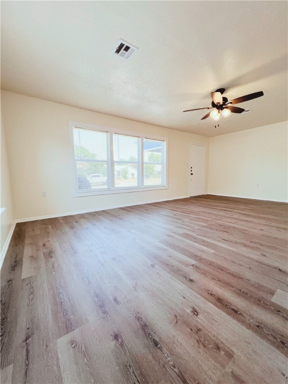 spare room featuring light hardwood / wood-style flooring and ceiling fan