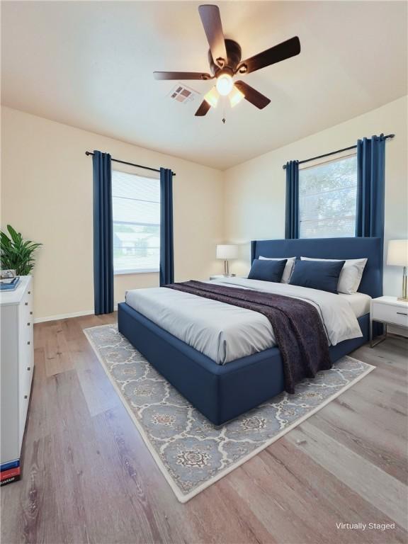 bedroom featuring ceiling fan and light wood-type flooring