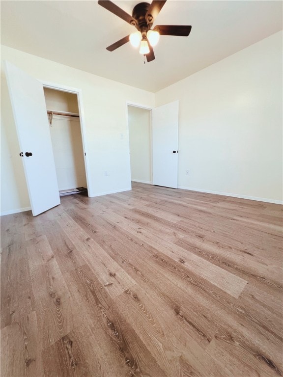 unfurnished bedroom featuring ceiling fan, a closet, and light hardwood / wood-style floors