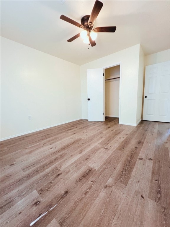 unfurnished bedroom with ceiling fan, light hardwood / wood-style floors, and a closet