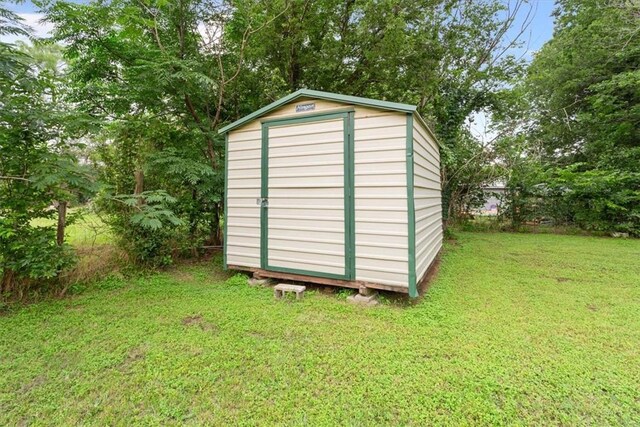 view of outdoor structure with a lawn