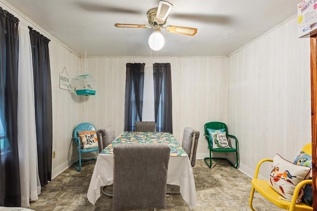 dining space featuring ceiling fan and crown molding