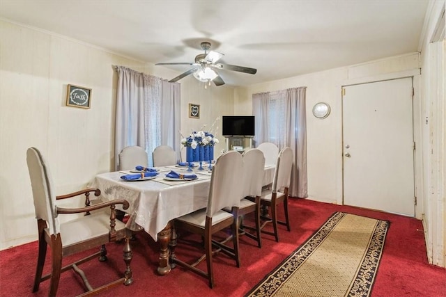 dining area with dark colored carpet, ceiling fan, and crown molding