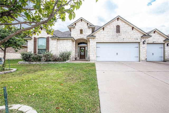 view of front of property with a front yard and a garage