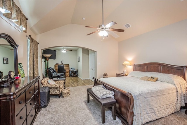 bedroom featuring ceiling fan, light hardwood / wood-style floors, and vaulted ceiling