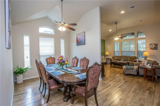 dining area with wood-type flooring, vaulted ceiling, and ceiling fan