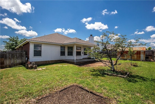 back of property featuring a patio and a lawn