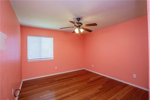 spare room with hardwood / wood-style floors and ceiling fan