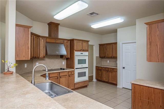 kitchen featuring white double oven, ventilation hood, backsplash, and sink