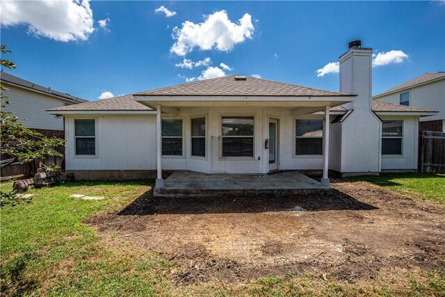 back of property featuring a yard and a patio