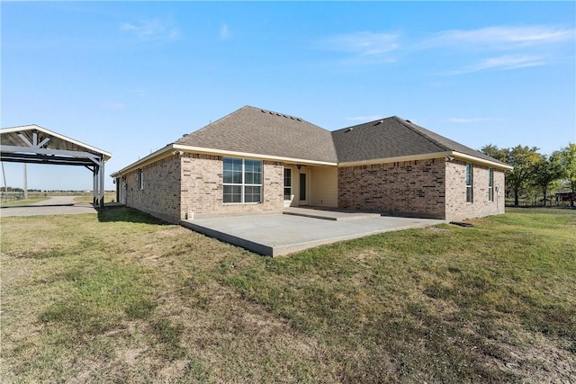 rear view of house with a yard and a patio area