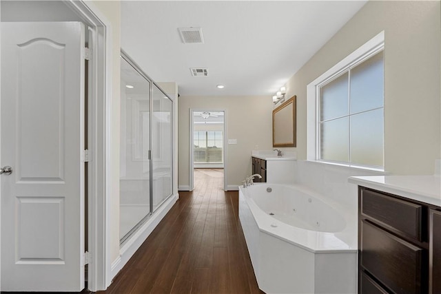 bathroom with wood-type flooring, vanity, separate shower and tub, and ceiling fan