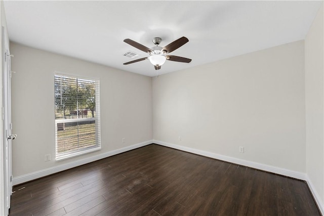 empty room featuring ceiling fan and dark hardwood / wood-style flooring