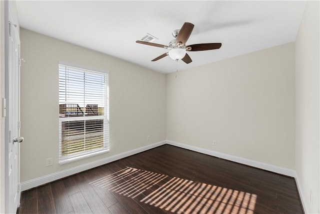 spare room featuring dark hardwood / wood-style floors and ceiling fan